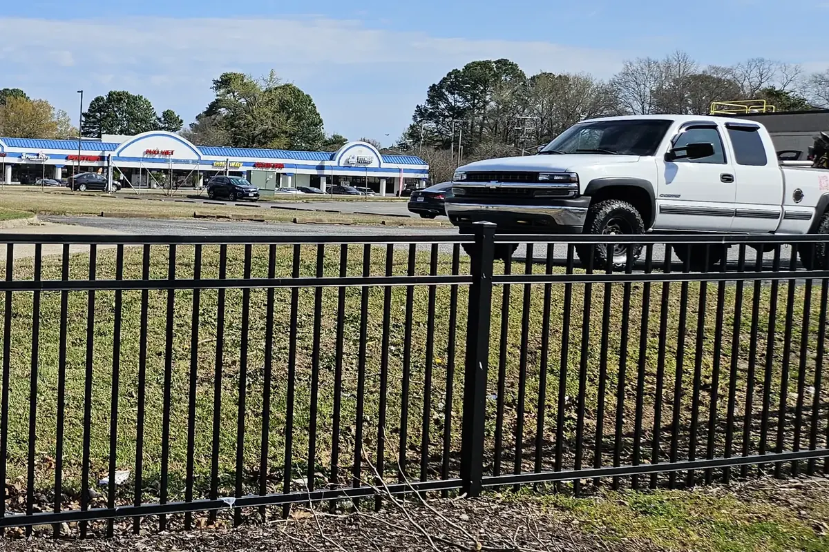 Black aluminum fence with flat-top pickets installed by VB Fences