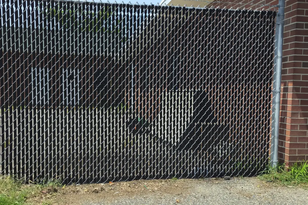 Black privacy-slat chain link fence at a commercial property